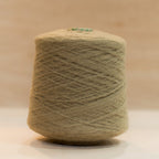 Cheekyarn Loop 8 yarn cone in Pub Stool, a warm worn mid-toned brown, against a natural wood background