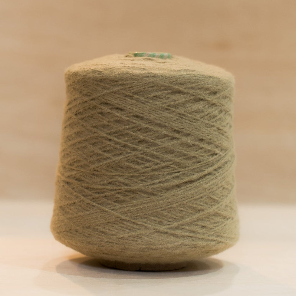 Cheekyarn Loop 8 yarn cone in Pub Stool, a warm worn mid-toned brown, against a natural wood background