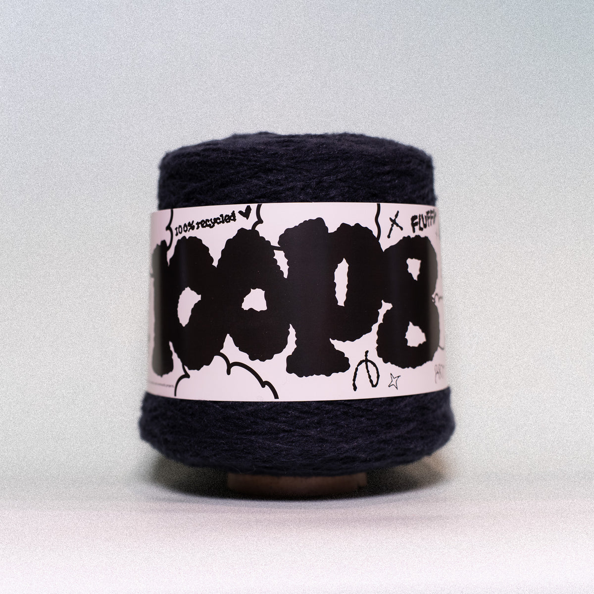 Cheekyarn Loop 8 yarn cone in Dark Club, a very dark near-black navy, 600g recycled super bulky tufting yarn