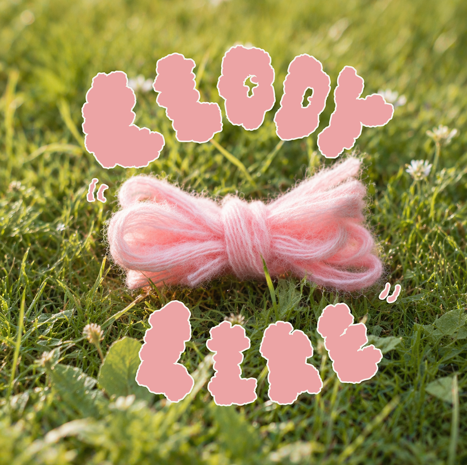 Pink Loop 8 recycled polyester yarn sample on grass with playful lettering, ideal for tufting, knitting and textile art