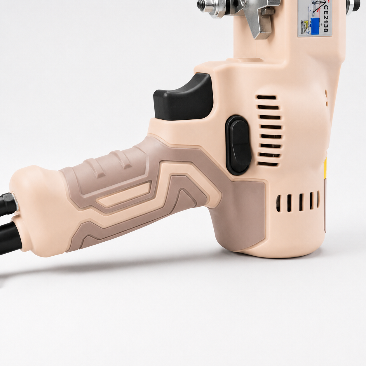 Close-up of the AK-V Desert Brown ergonomic grip, trigger and motor vents — UK Tufting