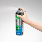 Hand holding a can of Wise 100% Green Cleaning Detergent against a gray background