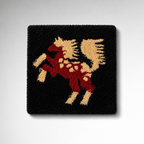 Black handmade tufted rug with red and beige griffin artwork, created using Loop 8 recycled polyester yarn for a bold textured rug finish